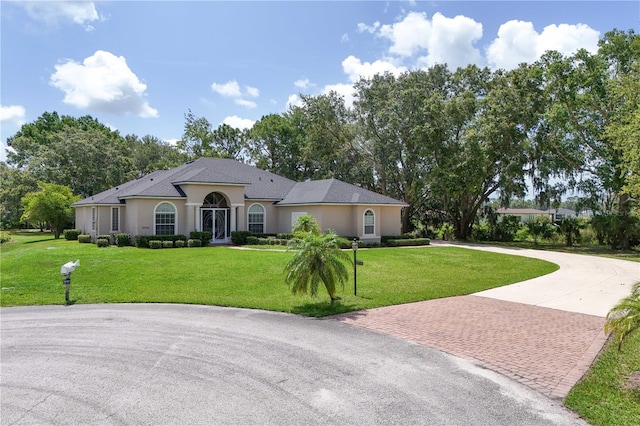 29152 David Ct, Tavares, FL 32778 - view of front of property featuring decorative driveway, a front yard, and stucco siding