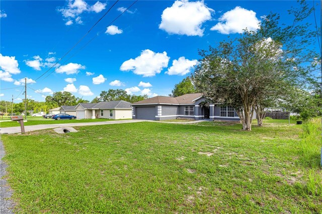 70 Locust Pass Run, Ocala, FL 34472 - single story home with concrete driveway, a garage, and a front yard