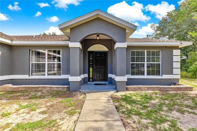 70 Locust Pass Run, Ocala, FL 34472 - property entrance with stucco siding and a shingled roof