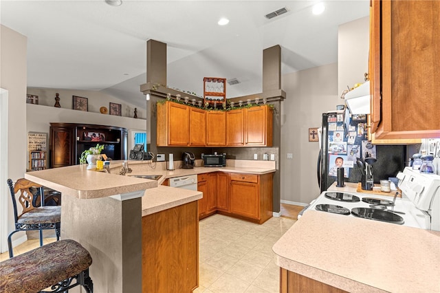 70 Locust Pass Run, Ocala, FL 34472 - kitchen featuring white appliances, a kitchen breakfast bar, a peninsula, vaulted ceiling, and light countertops