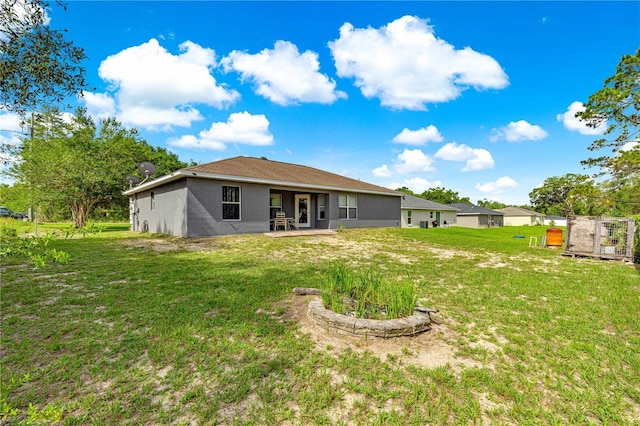70 Locust Pass Run, Ocala, FL 34472 - rear view of house with a yard, a patio area, and stucco siding