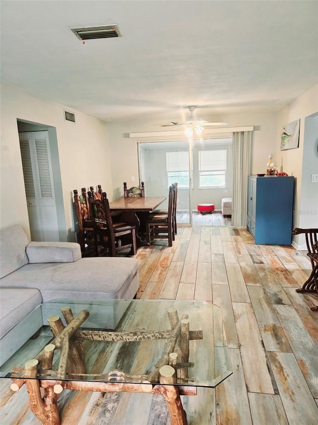 2433 Adams Ave, Deltona, FL 32738 - living room with light wood-style flooring and ceiling fan