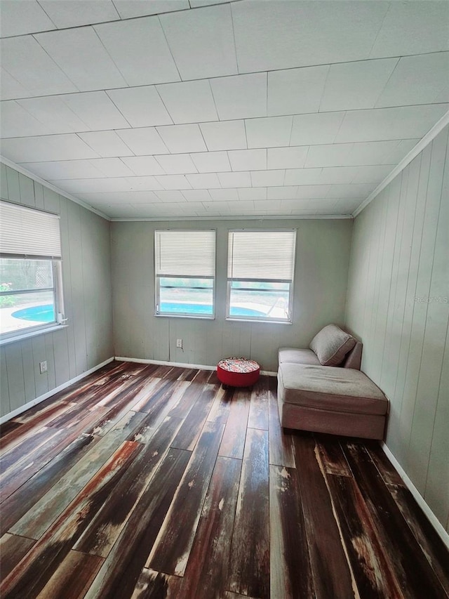 2433 Adams Ave, Deltona, FL 32738 - living area featuring hardwood / wood-style floors, crown molding, healthy amount of natural light, wood walls, and baseboards