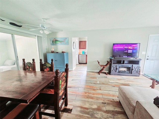 2433 Adams Ave, Deltona, FL 32738 - living area featuring light wood-style flooring, ceiling fan, a fireplace, and baseboards