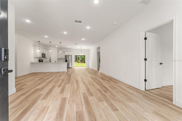 1809 W Linden Dr, Citrus Springs, FL 34434 - unfurnished living room featuring light wood-style floors and recessed lighting