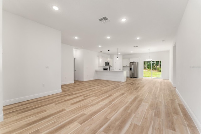 1809 W Linden Dr, Citrus Springs, FL 34434 - unfurnished living room featuring recessed lighting, light wood finished floors, and a chandelier