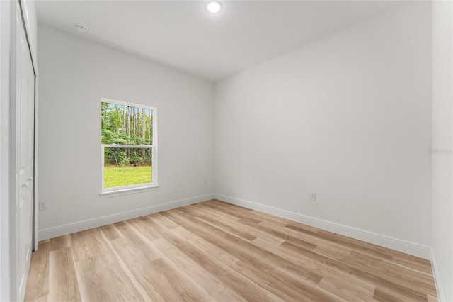 1809 W Linden Dr, Citrus Springs, FL 34434 - empty room with light wood finished floors, a smoke detector, and recessed lighting