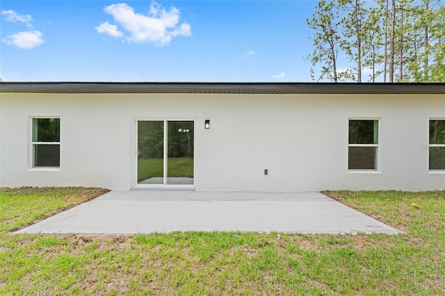 1809 W Linden Dr, Citrus Springs, FL 34434 - back of property featuring stucco siding, a patio, and a yard