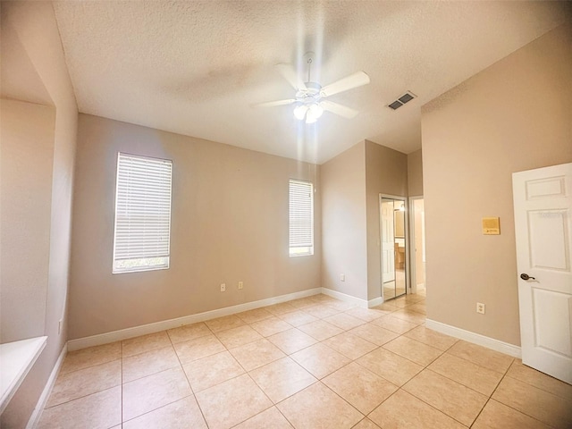 1180 Mesa Verde Ct, Clermont, FL 34711 - spare room featuring light tile patterned flooring, lofted ceiling, a ceiling fan, and a textured ceiling