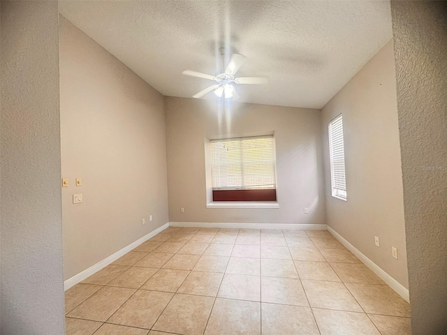 1180 Mesa Verde Ct, Clermont, FL 34711 - empty room featuring a textured ceiling, ceiling fan, light tile patterned flooring, baseboards, and a textured wall