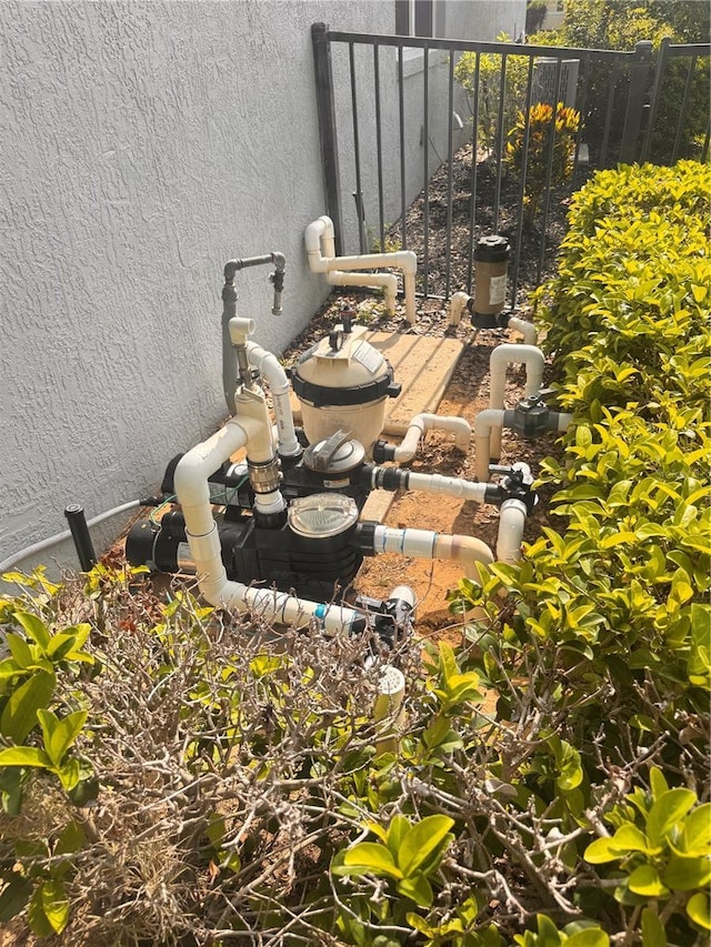 1180 Mesa Verde Ct, Clermont, FL 34711 - exterior view of stucco siding and pump