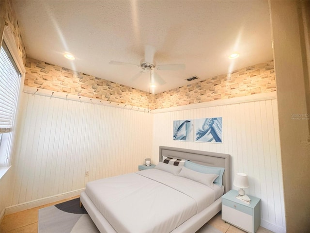 1180 Mesa Verde Ct, Clermont, FL 34711 - bedroom featuring a wainscoted wall, a ceiling fan, and a textured ceiling