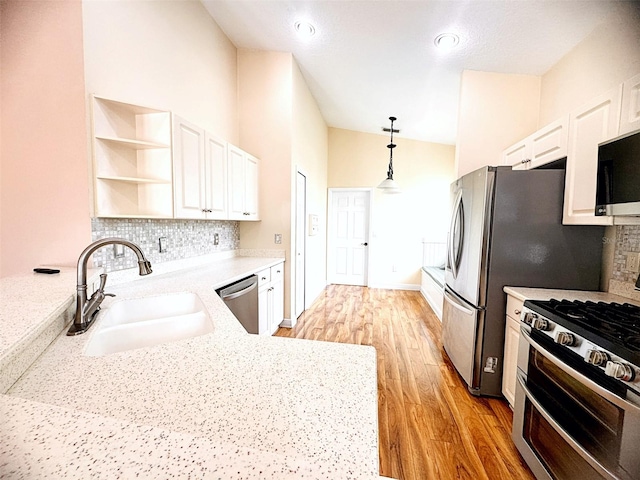 1180 Mesa Verde Ct, Clermont, FL 34711 - kitchen with appliances with stainless steel finishes, white cabinetry, open shelves, and light wood-style flooring