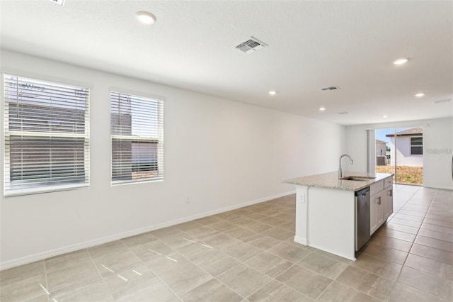 4973 Kaia Ave, Winter Haven, FL 33884 - kitchen with a sink, stainless steel dishwasher, light stone countertops, recessed lighting, and a center island with sink