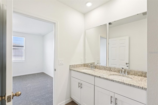 4973 Kaia Ave, Winter Haven, FL 33884 - bathroom with double vanity and baseboards