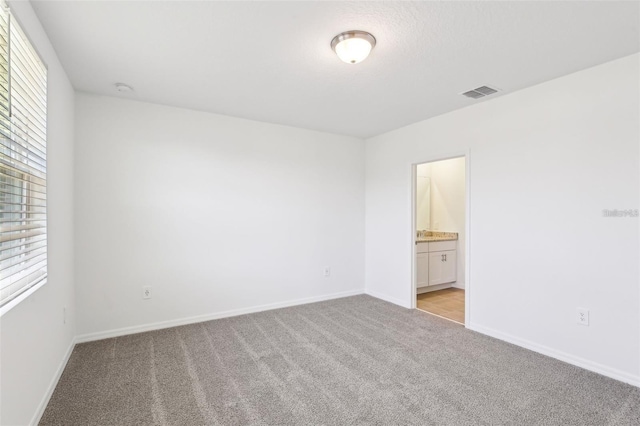 4973 Kaia Ave, Winter Haven, FL 33884 - spare room featuring light carpet, baseboards, and a smoke detector