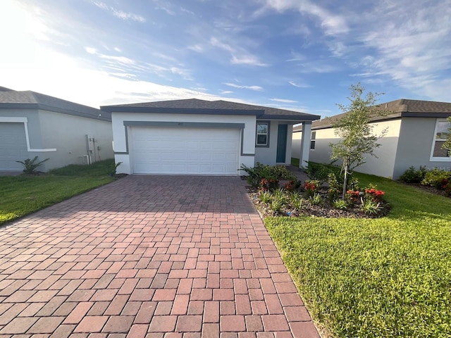 4957 Kaia Ave, Winter Haven, FL 33884 - ranch-style house with decorative driveway, a garage, a front yard, and stucco siding