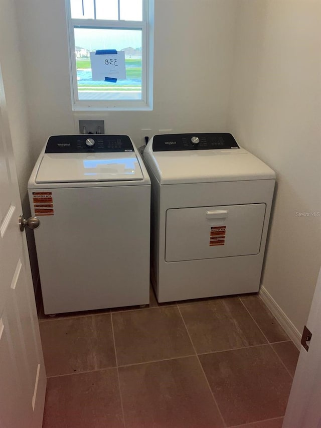 4957 Kaia Ave, Winter Haven, FL 33884 - washroom with independent washer and dryer, tile patterned flooring, and baseboards