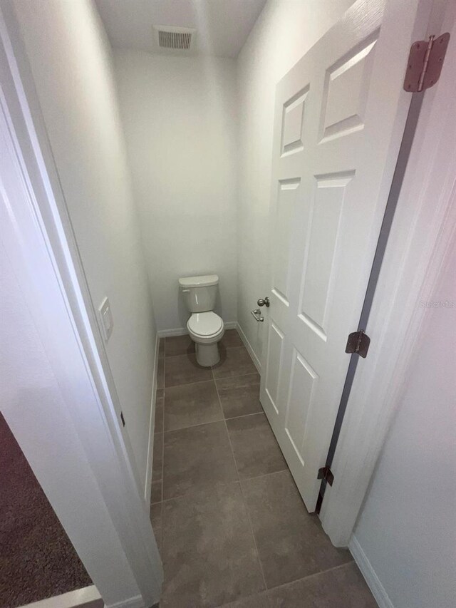 4957 Kaia Ave, Winter Haven, FL 33884 - bathroom with toilet, tile patterned floors, and baseboards