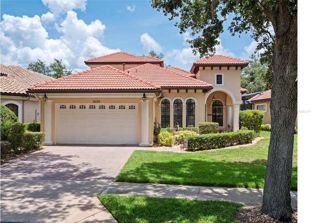 9335 San Jose Blvd, Howey In The Hills, FL 34737 - mediterranean / spanish-style house with stucco siding, an attached garage, driveway, a front yard, and a tile roof