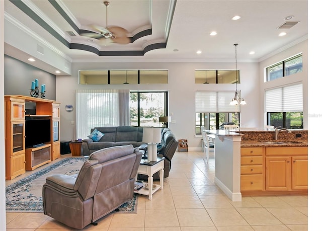 9335 San Jose Blvd, Howey In The Hills, FL 34737 - living room featuring crown molding, a towering ceiling, plenty of natural light, ceiling fan, and light tile patterned floors