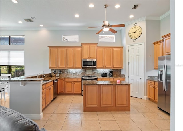 9335 San Jose Blvd, Howey In The Hills, FL 34737 - kitchen featuring stainless steel appliances, a peninsula, ornamental molding, tasteful backsplash, and a center island