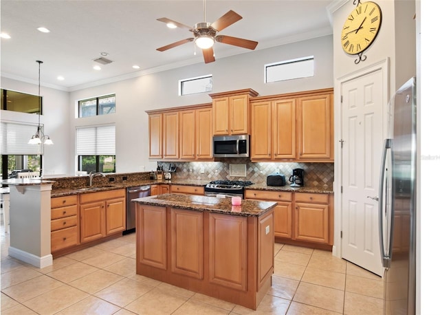 9335 San Jose Blvd, Howey In The Hills, FL 34737 - kitchen featuring stainless steel appliances, a peninsula, crown molding, decorative backsplash, and a kitchen island