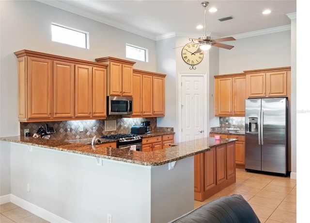 9335 San Jose Blvd, Howey In The Hills, FL 34737 - kitchen featuring stainless steel appliances, dark stone countertops, a peninsula, light tile patterned floors, and a towering ceiling
