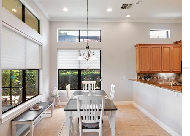 9335 San Jose Blvd, Howey In The Hills, FL 34737 - dining space featuring light tile patterned floors, crown molding, a towering ceiling, and recessed lighting