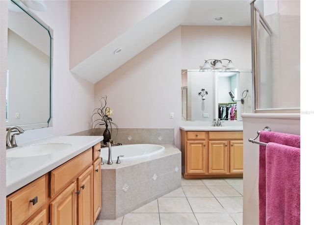 9335 San Jose Blvd, Howey In The Hills, FL 34737 - bathroom with two vanities, tile patterned flooring, and a garden tub