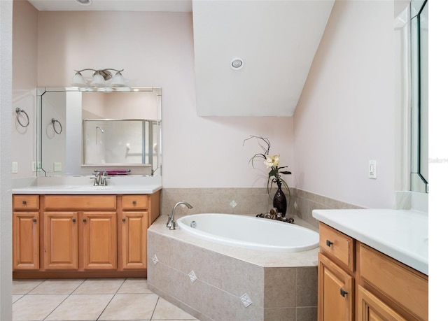 9335 San Jose Blvd, Howey In The Hills, FL 34737 - bathroom with two vanities, a shower stall, a bath, and tile patterned floors