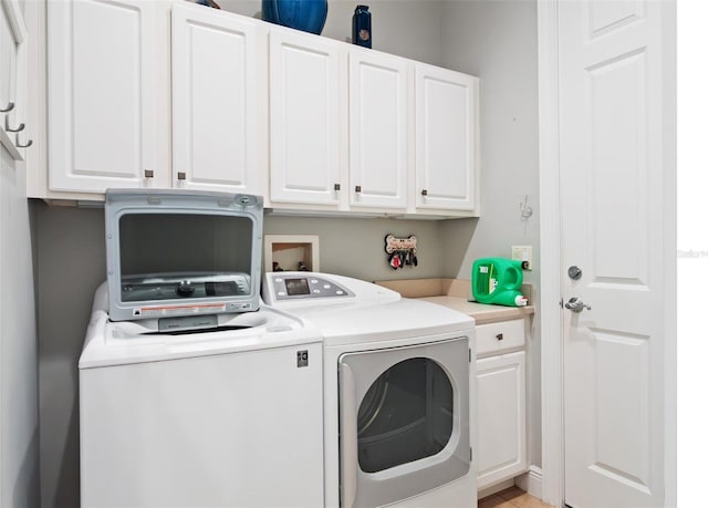 9335 San Jose Blvd, Howey In The Hills, FL 34737 - laundry area with washer and clothes dryer and cabinet space