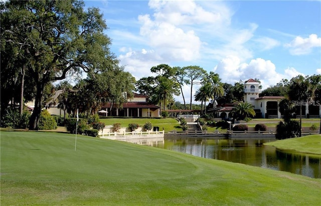 9335 San Jose Blvd, Howey In The Hills, FL 34737 - view of home's community featuring a water view, a putting green, a lawn, and golf course view