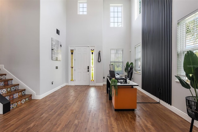 637 Neptune Dr, Groveland, FL 34736 - foyer featuring a high ceiling, dark wood-style floors, baseboards, plenty of natural light, and stairs