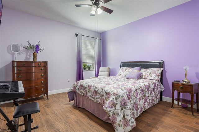 637 Neptune Dr, Groveland, FL 34736 - bedroom featuring baseboards, wood finished floors, and a ceiling fan