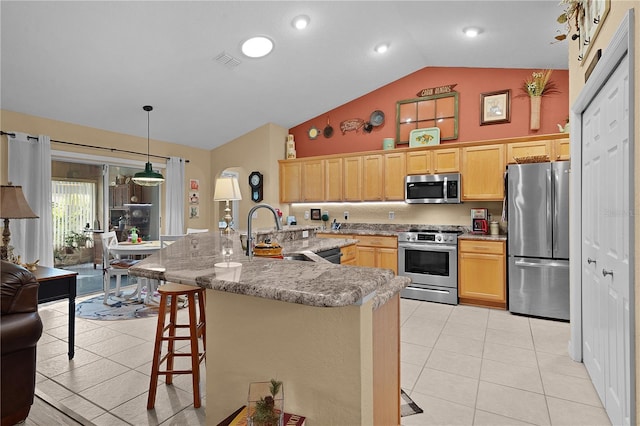 17355 SE 110th Ter, Summerfield, FL 34491 - kitchen featuring stainless steel appliances, high vaulted ceiling, a kitchen bar, light tile patterned floors, and light brown cabinets