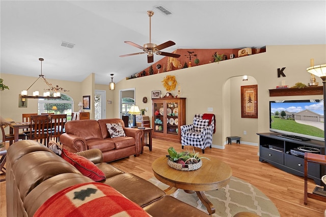 17355 SE 110th Ter, Summerfield, FL 34491 - living area featuring light wood-type flooring, arched walkways, a chandelier, ceiling fan, and high vaulted ceiling