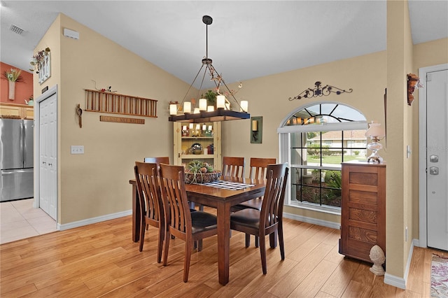 17355 SE 110th Ter, Summerfield, FL 34491 - dining room featuring a chandelier, light wood-style flooring, and lofted ceiling