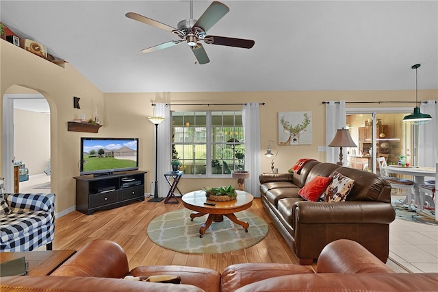 17355 SE 110th Ter, Summerfield, FL 34491 - living room with lofted ceiling, arched walkways, a ceiling fan, and wood finished floors