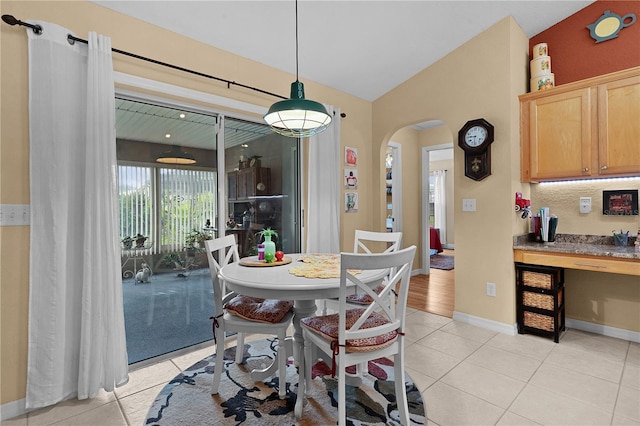 17355 SE 110th Ter, Summerfield, FL 34491 - dining area featuring arched walkways, light tile patterned floors, and lofted ceiling