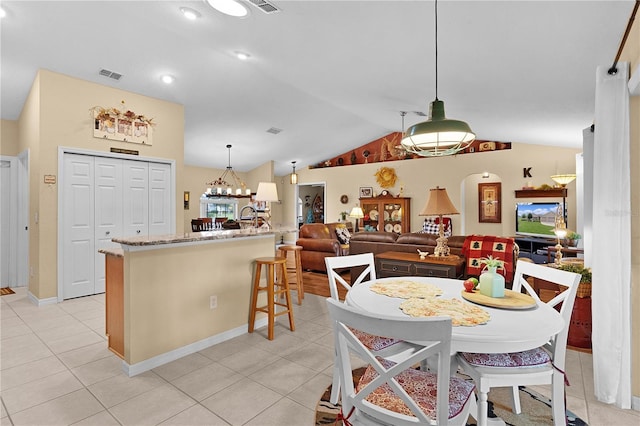 17355 SE 110th Ter, Summerfield, FL 34491 - dining space featuring vaulted ceiling, light tile patterned floors, a chandelier, and recessed lighting