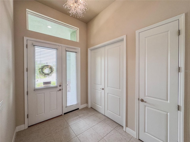 3021 King Palm Dr, New Smyrna Beach, FL 32168 - entryway featuring a chandelier and light tile patterned flooring