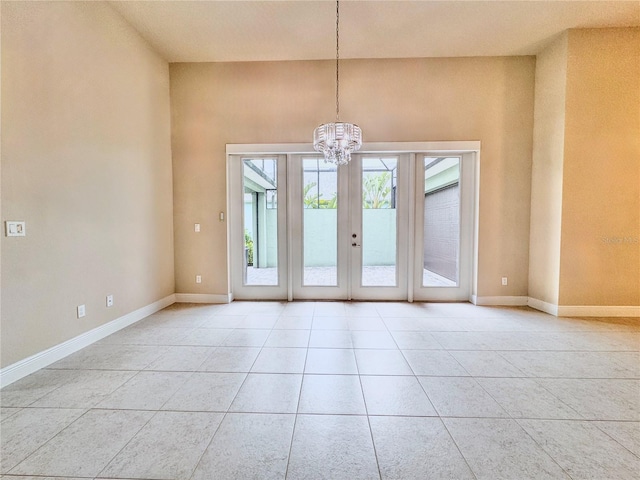 3021 King Palm Dr, New Smyrna Beach, FL 32168 - tiled empty room with a chandelier and baseboards