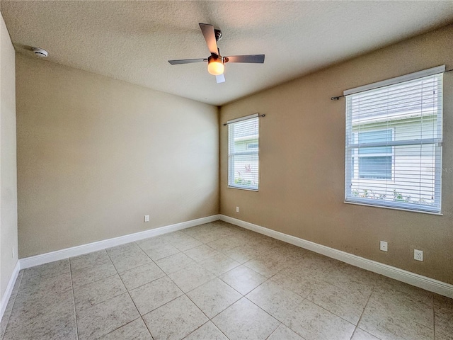 3021 King Palm Dr, New Smyrna Beach, FL 32168 - empty room with ceiling fan, a smoke detector, light tile patterned floors, and a textured ceiling