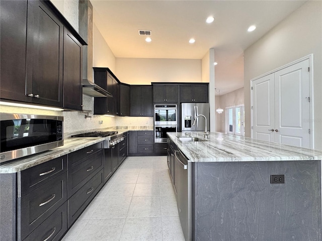 3021 King Palm Dr, New Smyrna Beach, FL 32168 - kitchen featuring stainless steel appliances, light stone counters, tasteful backsplash, an island with sink, and recessed lighting