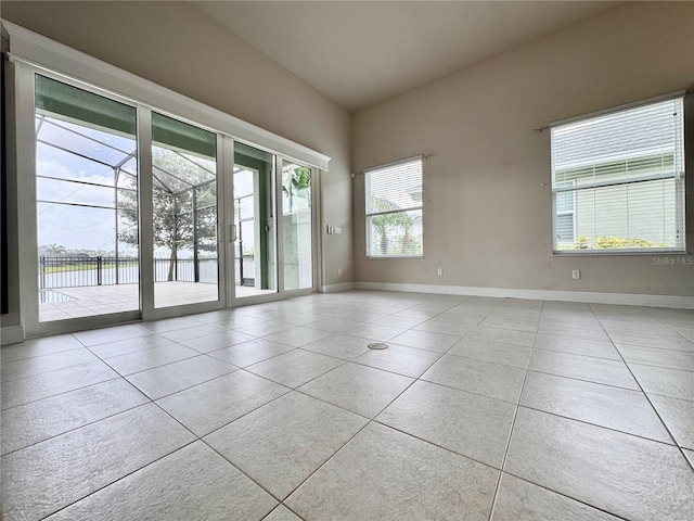 3021 King Palm Dr, New Smyrna Beach, FL 32168 - unfurnished room with baseboards and tile patterned flooring