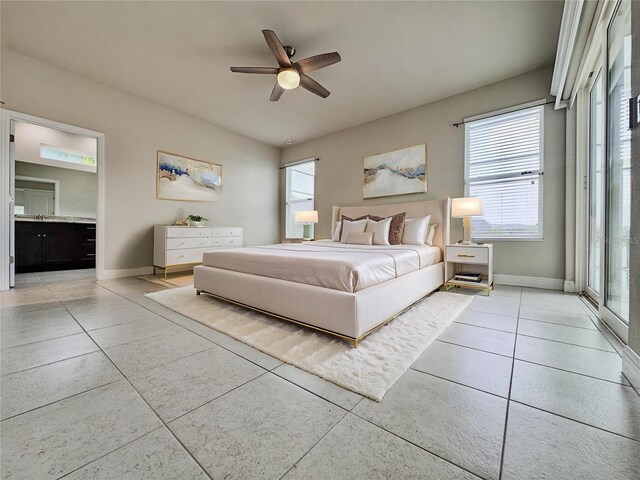 3021 King Palm Dr, New Smyrna Beach, FL 32168 - bedroom with light tile patterned floors, ceiling fan, access to exterior, and connected bathroom