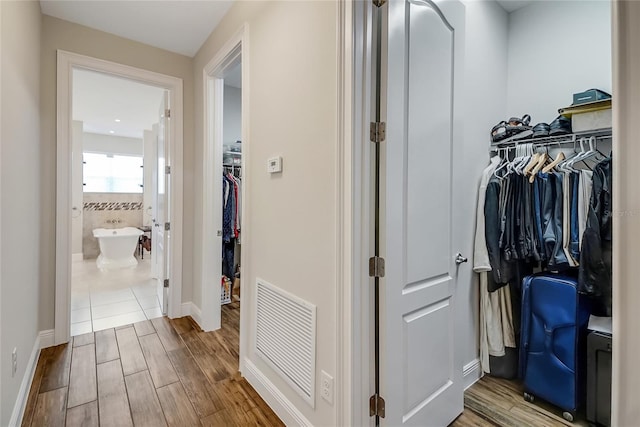 6008 Apex Way, Lady Lake, FL 32159 - corridor featuring wood finished floors and baseboards