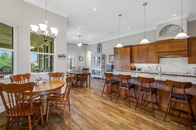 6008 Apex Way, Lady Lake, FL 32159 - dining area featuring dark wood finished floors, crown molding, ceiling fan, a chandelier, and recessed lighting