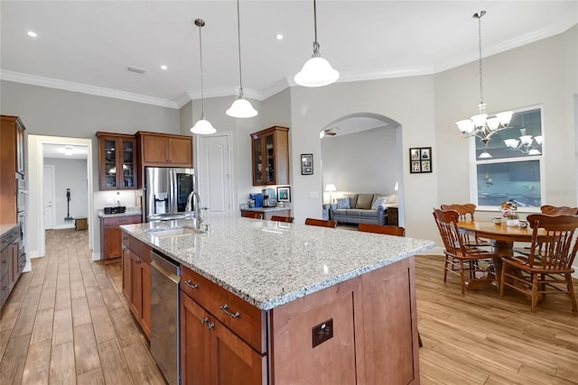 6008 Apex Way, Lady Lake, FL 32159 - kitchen with a sink, arched walkways, light wood-type flooring, stainless steel appliances, and ornamental molding